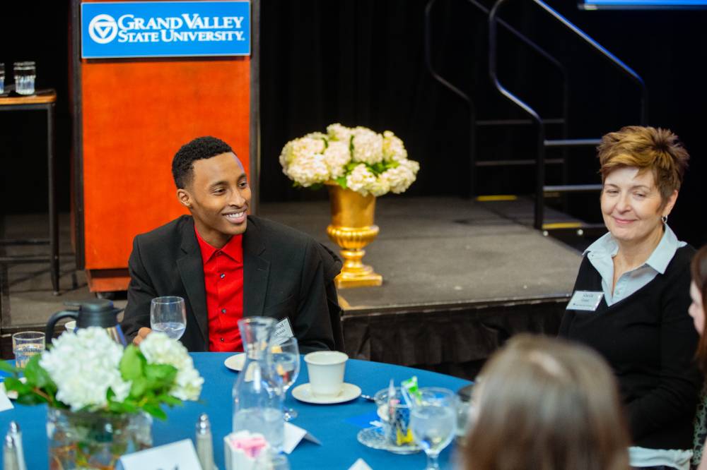 Guests sitting at a table in front of a podium at Scholarship Dinner 2019